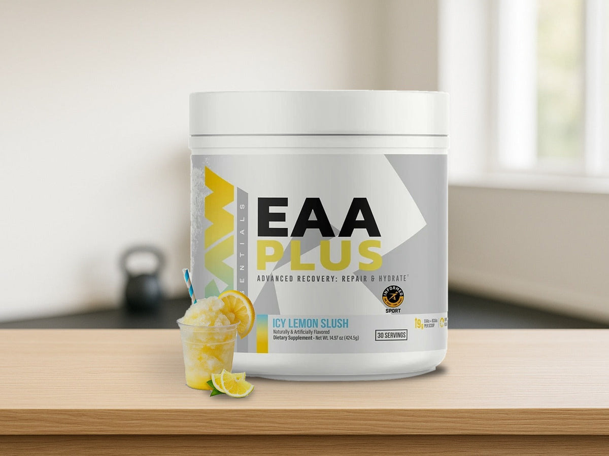 RAW EAA+ Essential Amino Acids Icy Lemon Slush tub on a light oak counter in a bright home gym with soft morning window light, product clearly in focus